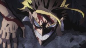 My Hero Academia still: All Might lies prone on shattered asphalt, blood streaking his brow and forearms, yet he flashes a fierce, defiant grin. His blue eyes burn beneath shadowed brows; golden forelocks arc around his face like lightning. Dust flecks and rubble frame a low, skewed close‑up that emphasizes impact and grit.